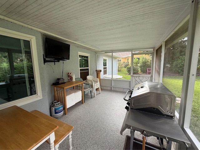 sunroom / solarium with a hot tub and wooden ceiling