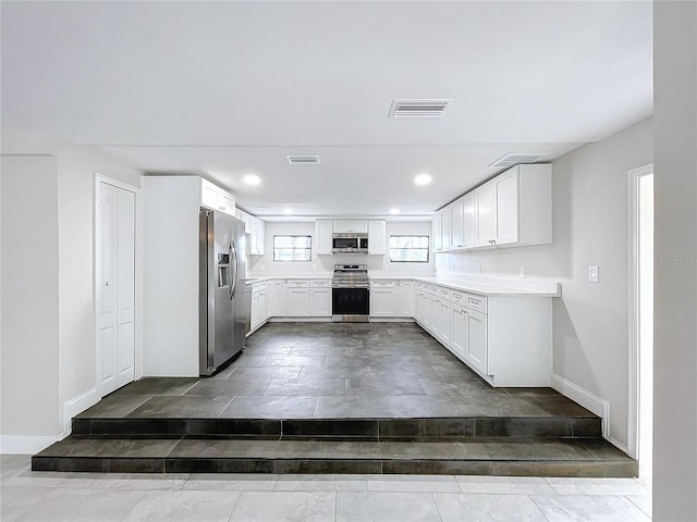 kitchen featuring white cabinetry and appliances with stainless steel finishes