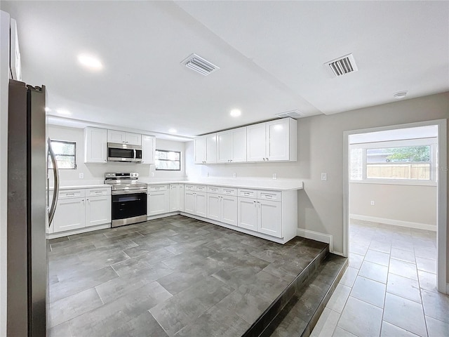 kitchen featuring white cabinets and appliances with stainless steel finishes