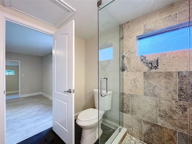 bathroom featuring toilet and an enclosed shower