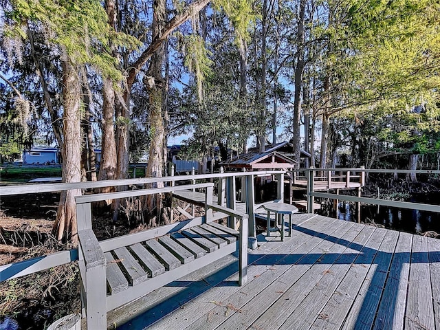 view of dock with a deck with water view