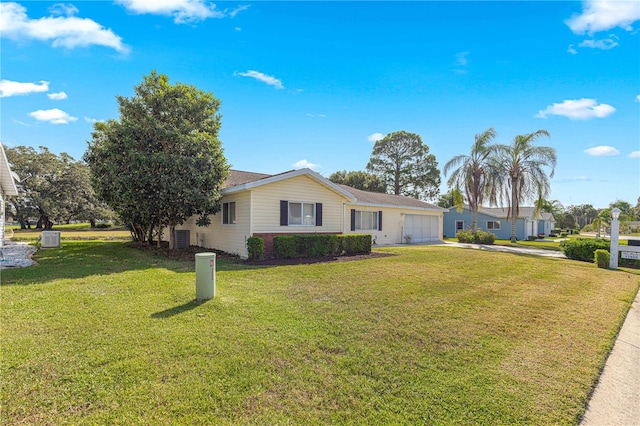 single story home with a front yard and a garage