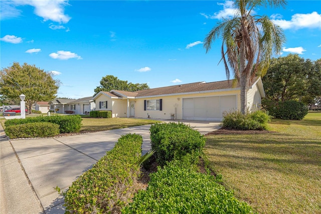 single story home with a front yard and a garage