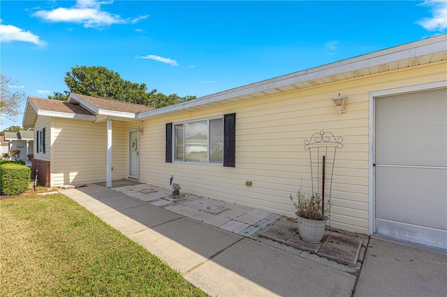 exterior space with a yard and a garage