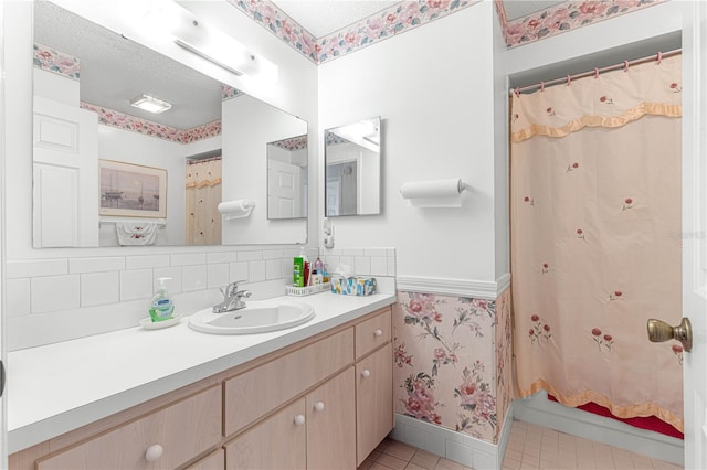 bathroom featuring a shower with shower curtain, tasteful backsplash, a textured ceiling, vanity, and tile patterned flooring