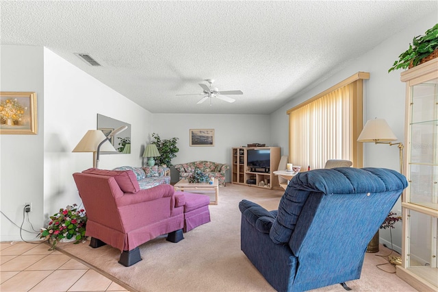 living room with ceiling fan, carpet, and a textured ceiling