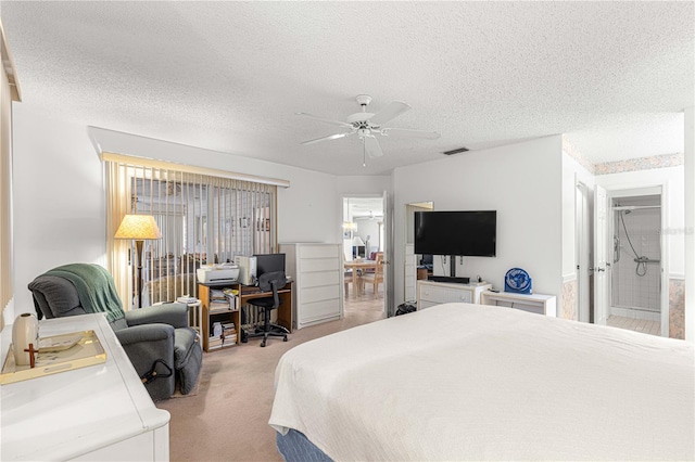 carpeted bedroom with a textured ceiling, ceiling fan, and connected bathroom