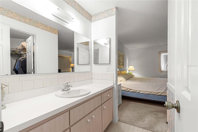 bathroom with tile patterned flooring and a textured ceiling