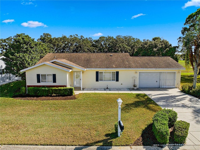 ranch-style house with a garage and a front lawn