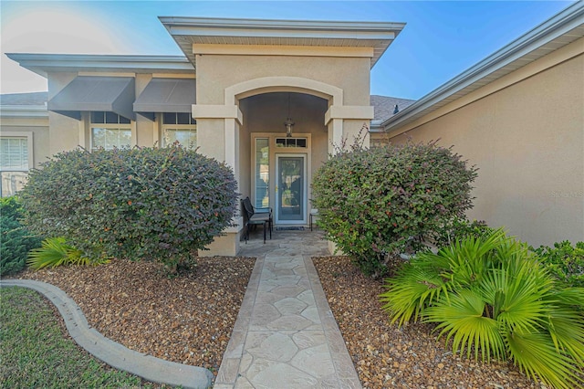 entrance to property with stucco siding