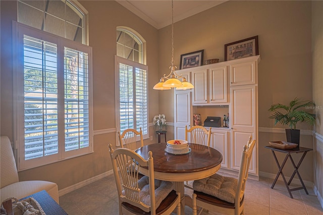 dining space with light tile patterned floors, baseboards, and ornamental molding