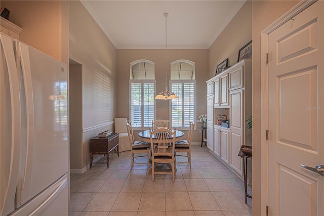 dining room with light tile patterned floors and crown molding