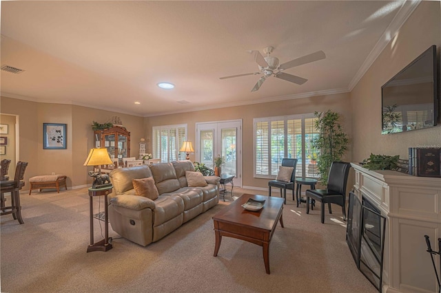 carpeted living room featuring ceiling fan and crown molding