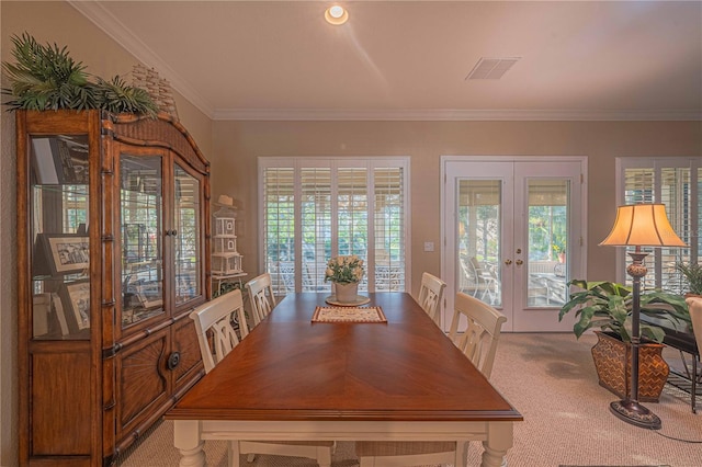 unfurnished dining area with ornamental molding, french doors, carpet flooring, and visible vents