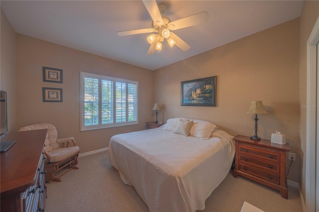 bedroom with light carpet and ceiling fan