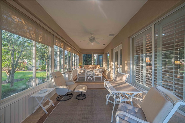 unfurnished sunroom with plenty of natural light and ceiling fan