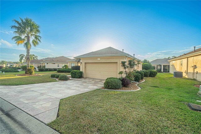 view of front facade featuring a garage, central AC unit, concrete driveway, stucco siding, and a front yard