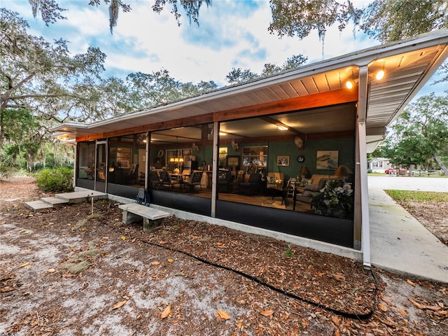 rear view of house featuring a sunroom