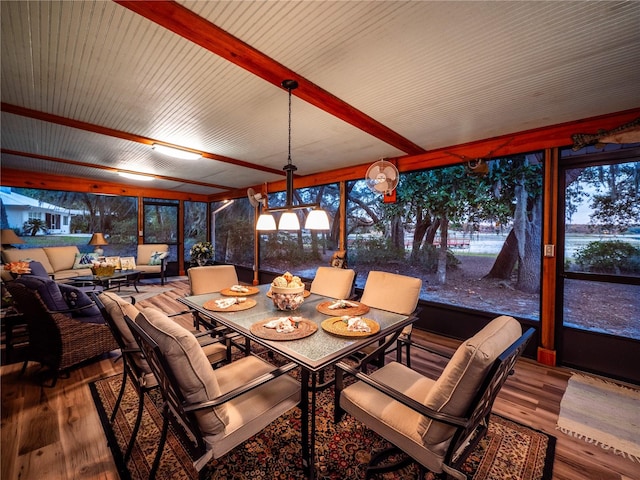 sunroom featuring beam ceiling