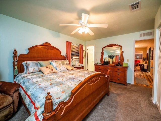 bedroom with ceiling fan and dark carpet