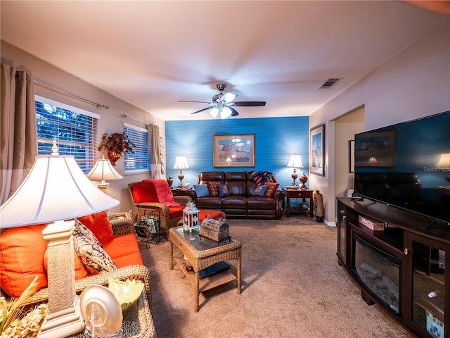 carpeted living room with ceiling fan