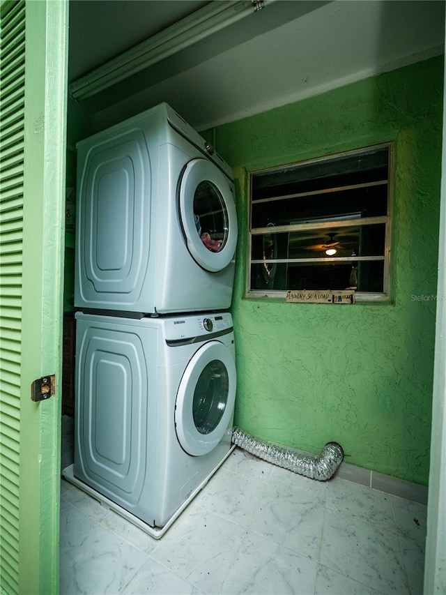 laundry room featuring stacked washer / dryer