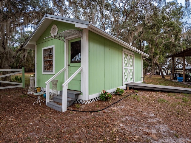 view of property exterior with an outdoor structure