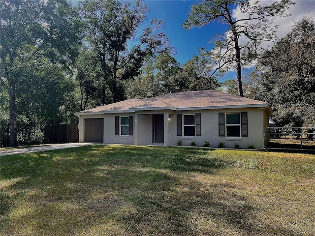 ranch-style home featuring a garage and a front lawn