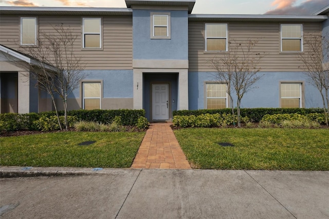 view of property featuring a yard