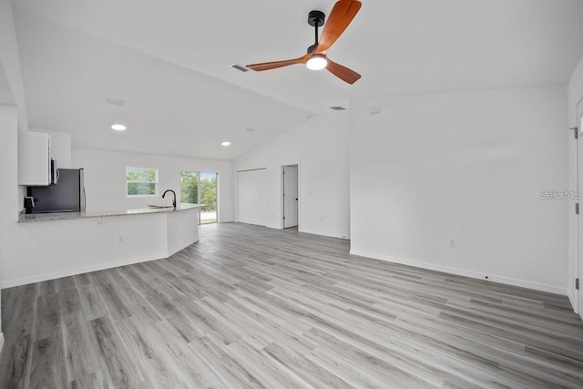 2688 SW Wave Ln, Dunnellon, FL 34431 - unfurnished living room featuring a sink, a ceiling fan, light wood finished floors, vaulted ceiling, and recessed lighting