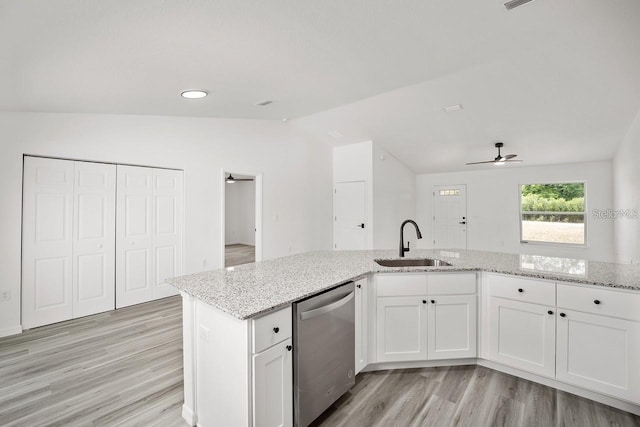 kitchen with sink, dishwasher, light hardwood / wood-style floors, white cabinetry, and lofted ceiling