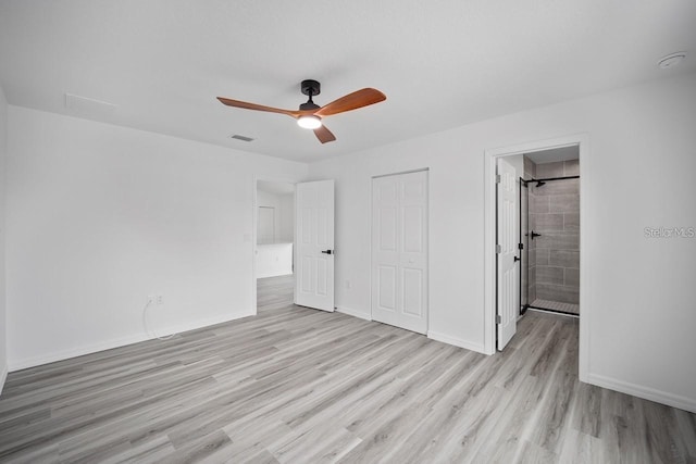 unfurnished bedroom with ceiling fan, a closet, ensuite bathroom, and light hardwood / wood-style floors