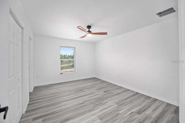 unfurnished room with ceiling fan and light wood-type flooring