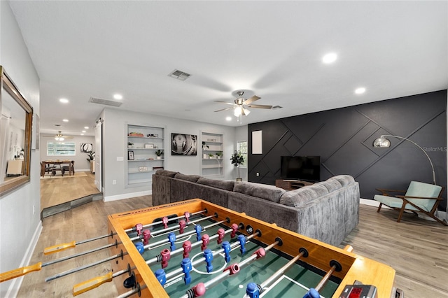 living room featuring wood-type flooring and ceiling fan