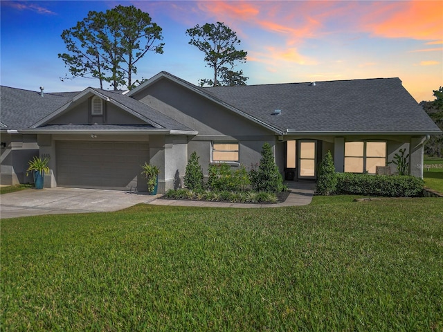 ranch-style home with a lawn and a garage