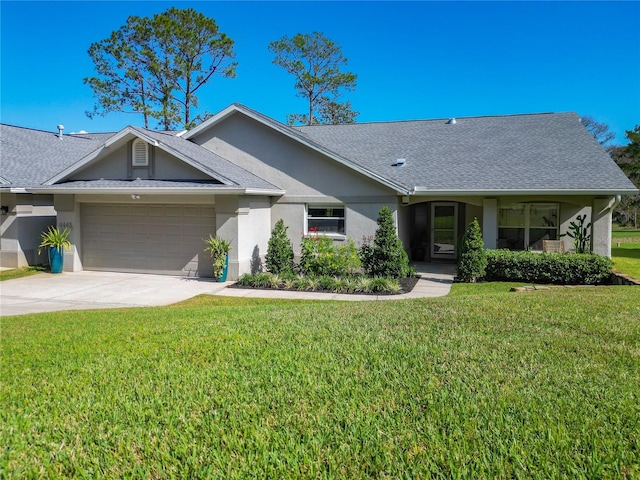 single story home with a garage and a front lawn