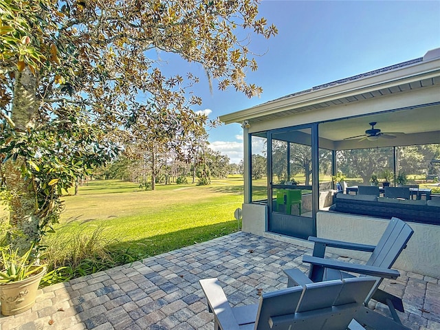 view of patio / terrace with a sunroom and ceiling fan