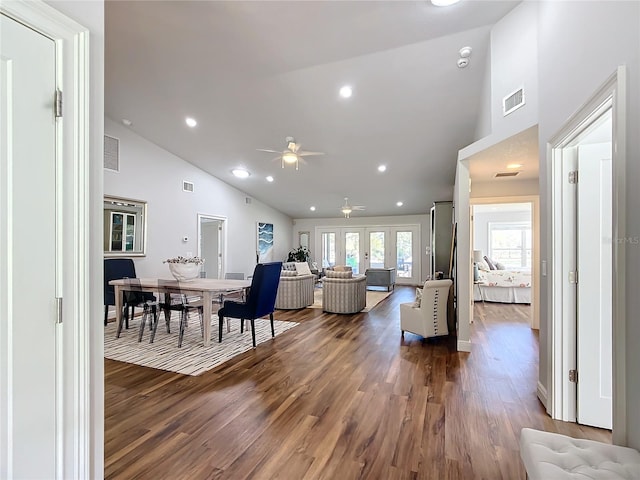 living room with ceiling fan, dark hardwood / wood-style flooring, high vaulted ceiling, and french doors