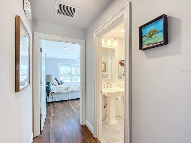 hallway with dark hardwood / wood-style floors and sink