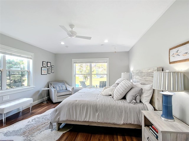 bedroom with multiple windows, ceiling fan, and dark wood-type flooring