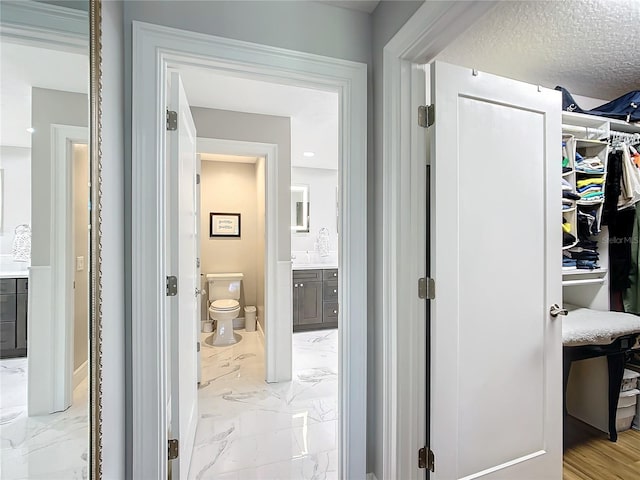 hall with a textured ceiling