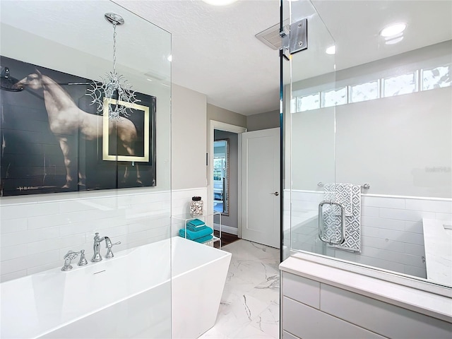 bathroom with plenty of natural light and a bath