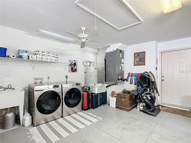 washroom with a textured ceiling, electric water heater, heating unit, ceiling fan, and washer and dryer