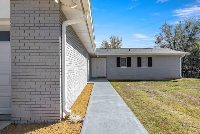 entrance to property with a yard