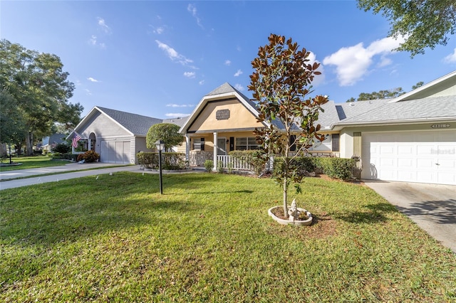 view of front of property with a porch, a garage, and a front lawn