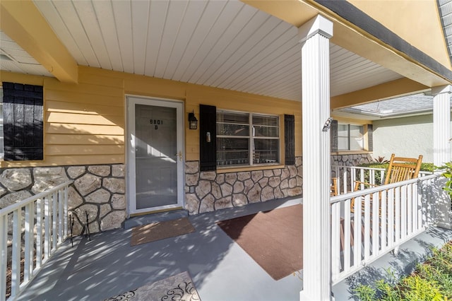 view of exterior entry with a porch