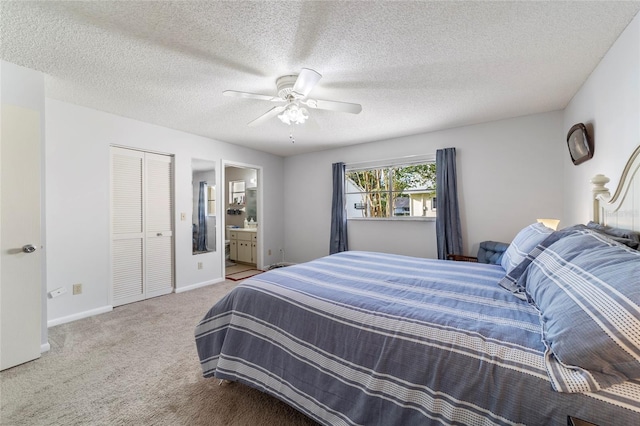 bedroom featuring a textured ceiling, connected bathroom, a closet, and ceiling fan