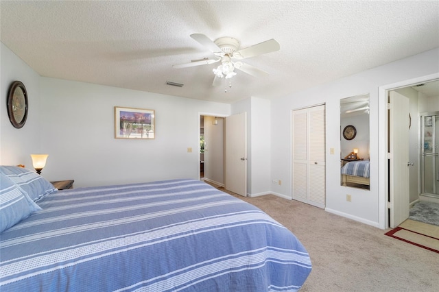 bedroom with ceiling fan, light colored carpet, a textured ceiling, and a closet