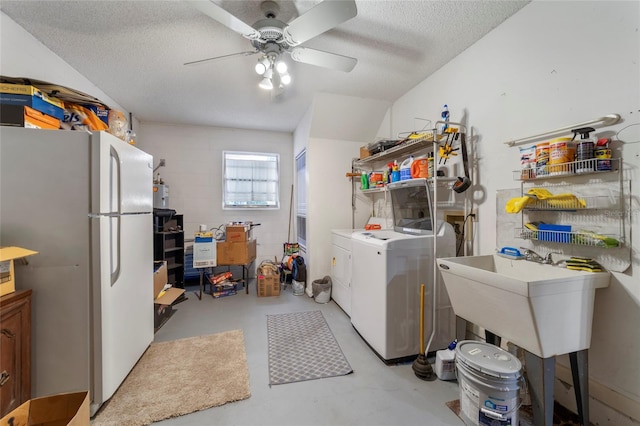 washroom featuring a textured ceiling, separate washer and dryer, ceiling fan, and sink