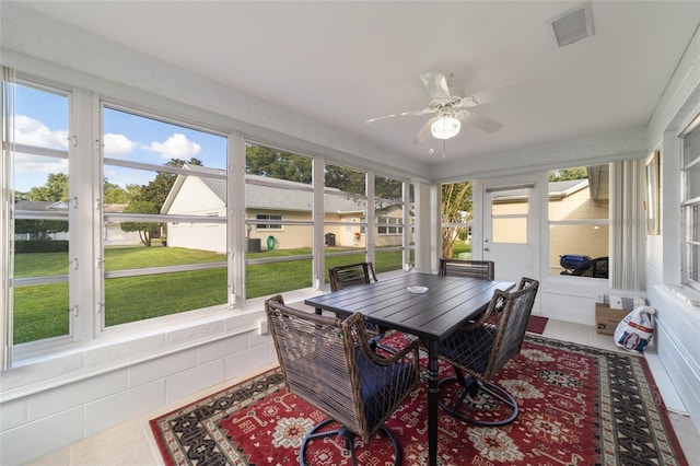 sunroom / solarium featuring ceiling fan